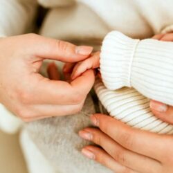 Baby hand held by mum