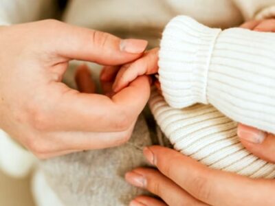 Baby hand held by mum